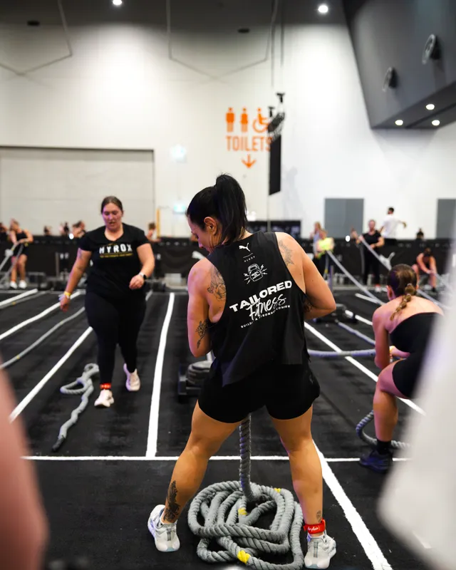A Tailored Fitness member on the battle ropes at a HYROX Perth event