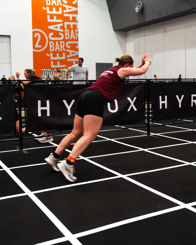 A competitor mid-throw on the wall balls at a HYROX Perth event